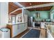 Open-concept kitchen featuring stainless steel appliances, granite countertops, and a wood-paneled ceiling at 3398 Lori Ln, Atlanta, GA 30340