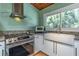 Updated kitchen with modern appliances, white cabinets, granite counters, and a farmhouse sink at 3398 Lori Ln, Atlanta, GA 30340