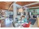 Open living space with a modern kitchen, dining area, and living room featuring hardwood floors and wood-paneled ceilings at 3398 Lori Ln, Atlanta, GA 30340