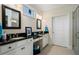 Bathroom featuring double sinks with granite counters, white cabinets, and a glass enclosed shower at 3470 Serenade Nw Commons, Kennesaw, GA 30152