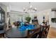 Bright dining room with hardwood floors, stylish chandelier, and large windows overlooking the backyard at 3470 Serenade Nw Commons, Kennesaw, GA 30152