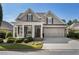 Charming home with a well-manicured lawn, a welcoming front porch, and an attached two-car garage at 3470 Serenade Nw Commons, Kennesaw, GA 30152