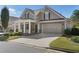 Charming home showcasing a well-manicured lawn, inviting entrance, and a convenient two-car garage at 3470 Serenade Nw Commons, Kennesaw, GA 30152