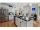 Bright kitchen featuring white cabinetry, black countertops, stainless steel appliances, and an island with bar seating at 3470 Serenade Nw Commons, Kennesaw, GA 30152