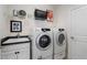 Well-equipped laundry room featuring a sink, shelving, and modern Samsung washer and dryer at 3470 Serenade Nw Commons, Kennesaw, GA 30152