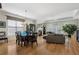 Open concept living room and dining area featuring hardwood floors, natural light, and a fireplace focal point at 3470 Serenade Nw Commons, Kennesaw, GA 30152