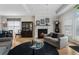 Open concept living room featuring fireplace, hardwood floors, and comfortable seating at 3470 Serenade Nw Commons, Kennesaw, GA 30152
