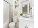 Bright bathroom features a white vanity, sleek black fixtures, and a modern shower with a stylish striped curtain at 185 Marion # A, Atlanta, GA 30307