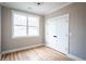 Cozy bedroom with beautiful hardwood floors, large window, and a closet with traditional paneled double doors at 185 Marion # A, Atlanta, GA 30307