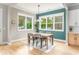 Cozy dining room featuring hardwood floors, large windows, and a stylish light fixture at 185 Marion # A, Atlanta, GA 30307