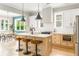 Bright kitchen with a modern island, stainless steel appliances, and an adjacent dining area at 185 Marion # A, Atlanta, GA 30307