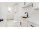 Well-lit laundry room featuring white cabinets, a stainless steel sink, and stylish patterned flooring at 185 Marion # A, Atlanta, GA 30307