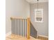 Stairway with hardwood treads, oak banister, black metal railings, and a view from the window at 185 Marion # A, Atlanta, GA 30307