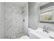 Updated bathroom featuring marble-look shower tiling, modern fixtures, and a sleek vanity at 2235 Chamois Ct, Decatur, GA 30035
