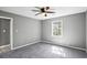 Cozy bedroom with soft carpet, ceiling fan, neutral paint, and bright window at 2235 Chamois Ct, Decatur, GA 30035