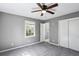 Cozy bedroom with plush gray carpet, a ceiling fan, and closet at 2235 Chamois Ct, Decatur, GA 30035