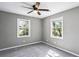 This bedroom features two windows, carpet and ceiling fan at 2235 Chamois Ct, Decatur, GA 30035