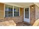 Covered entryway showcasing brick accents, natural light, and a welcoming front door at 2235 Chamois Ct, Decatur, GA 30035