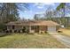 Charming brick ranch-style home with a single-car garage and well-maintained front yard at 2235 Chamois Ct, Decatur, GA 30035
