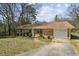 Classic brick home with an attached garage and a meticulously landscaped front yard at 2235 Chamois Ct, Decatur, GA 30035
