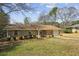 Charming home with brick exterior, lush landscaping, and attached garage at 2235 Chamois Ct, Decatur, GA 30035