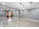 Open-concept living room with two flooring types, modern lighting, and open space at 2235 Chamois Ct, Decatur, GA 30035