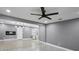 Open-concept living room with two flooring types, ceiling fan, fireplace, and modern fixtures at 2235 Chamois Ct, Decatur, GA 30035