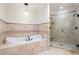 Bright bathroom boasts a soaking tub, a walk-in shower, and elegant neutral-tone finishes at 2881 Peachtree Ne Rd # 704, Atlanta, GA 30305