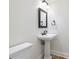 Cozy bathroom with a pedestal sink, classic mirror, and ample space, offering timeless appeal at 2881 Peachtree Ne Rd # 704, Atlanta, GA 30305