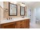 Dual sinks, marble countertops, framed mirrors, and modern fixtures add style to the bathroom at 2881 Peachtree Ne Rd # 704, Atlanta, GA 30305