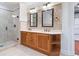 Bathroom features a double vanity, a glass-enclosed shower, and a mosaic tile backsplash at 2881 Peachtree Ne Rd # 704, Atlanta, GA 30305