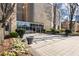 Building entrance with large glass doors, manicured landscaping, and a welcoming, sophisticated appeal at 2881 Peachtree Ne Rd # 704, Atlanta, GA 30305
