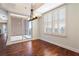 Bright dining area with hardwood floors, modern light fixture, and sliding glass doors to a balcony at 2881 Peachtree Ne Rd # 704, Atlanta, GA 30305