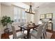 Bright dining room featuring plantation shutters, neutral paint, and wood floors; a rustic wooden table seats six at 2881 Peachtree Ne Rd # 704, Atlanta, GA 30305