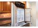 Kitchen view highlights stainless steel refrigerator, wine storage above the refrigerator, wooden cabinets, tile backsplash, and granite counters at 2881 Peachtree Ne Rd # 704, Atlanta, GA 30305