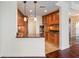 Kitchen area features wooden cabinets with granite countertops, stainless steel appliances, and wood flooring in an open floor plan at 2881 Peachtree Ne Rd # 704, Atlanta, GA 30305
