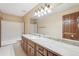 Bathroom featuring a large vanity with marble countertop, decorative lighting, and a shower-tub combination at 357 Forest Lake Rd, Lawrenceville, GA 30046