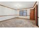 Bedroom with carpeted floors, window with wood blinds, and wood trim details, creating a cozy atmosphere at 357 Forest Lake Rd, Lawrenceville, GA 30046