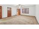 Bright bedroom features neutral carpet, a ceiling fan and two wood doors at 357 Forest Lake Rd, Lawrenceville, GA 30046