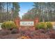 Entrance to Forest Hills community with brick sign surrounded by greenery at 357 Forest Lake Rd, Lawrenceville, GA 30046