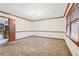Spacious dining room featuring carpeted floors, decorative molding, a chandelier, and natural light from the window at 357 Forest Lake Rd, Lawrenceville, GA 30046