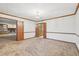Dining room with carpeted floors, a decorative chandelier and a doorway with views of the brick fireplace and built-ins at 357 Forest Lake Rd, Lawrenceville, GA 30046