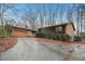 Charming single-story home with brick and dark siding, front yard landscaping and two-car garage at 357 Forest Lake Rd, Lawrenceville, GA 30046
