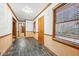 Hallway features dark tile floors, wood trim, and a window with natural light at 357 Forest Lake Rd, Lawrenceville, GA 30046