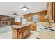 Open concept kitchen flows to a living room featuring a brick fireplace at 357 Forest Lake Rd, Lawrenceville, GA 30046