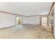 Bright, open-concept living room featuring neutral carpeting and views into other rooms of the home at 357 Forest Lake Rd, Lawrenceville, GA 30046