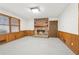 Inviting living room with a brick fireplace, wood paneling, and two large windows at 357 Forest Lake Rd, Lawrenceville, GA 30046