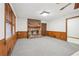 Cozy living room with a fireplace, wood paneling, and ample natural light at 357 Forest Lake Rd, Lawrenceville, GA 30046
