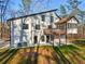 Rear view of home with spacious deck, screened porch, walkout basement and well-maintained lawn at 4013 Brenteresa Ct, Snellville, GA 30039