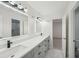 Modern bathroom with double vanity, granite countertops, and tile floors at 4013 Brenteresa Ct, Snellville, GA 30039